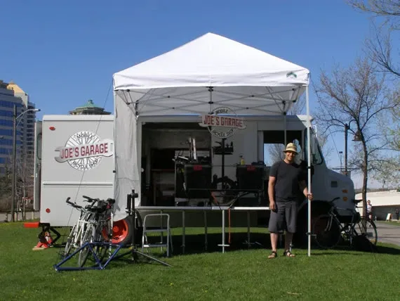 The full truck and tent setup with Joe standing beside it, 2011