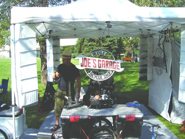 Joe's Garage Mobile Bicycle Shop, open for business under the tent with the original sign