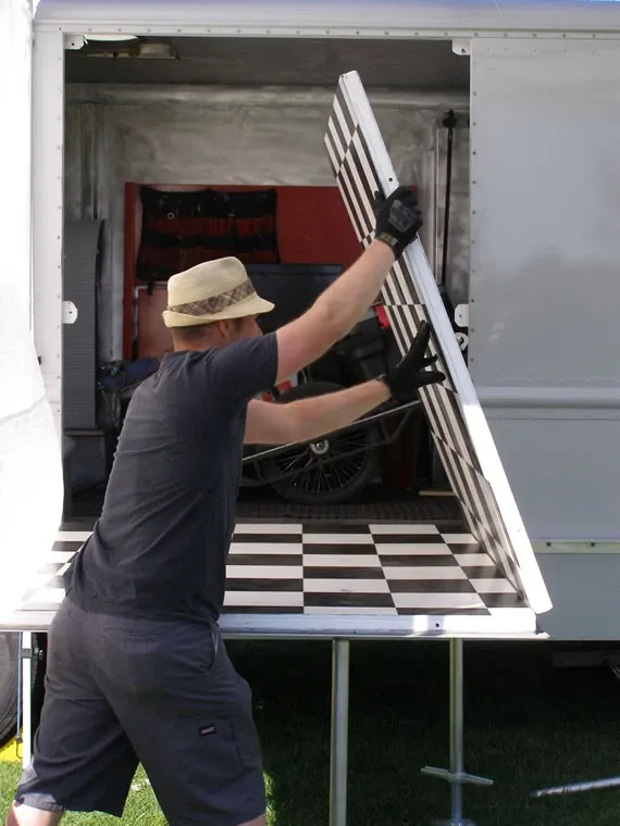 Joe opening up the work floor inside the truck, checkerboard floor visible