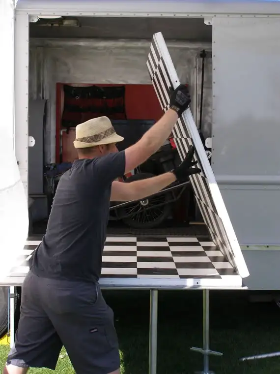 Joe opening up the work floor inside the truck, checkerboard floor visible
